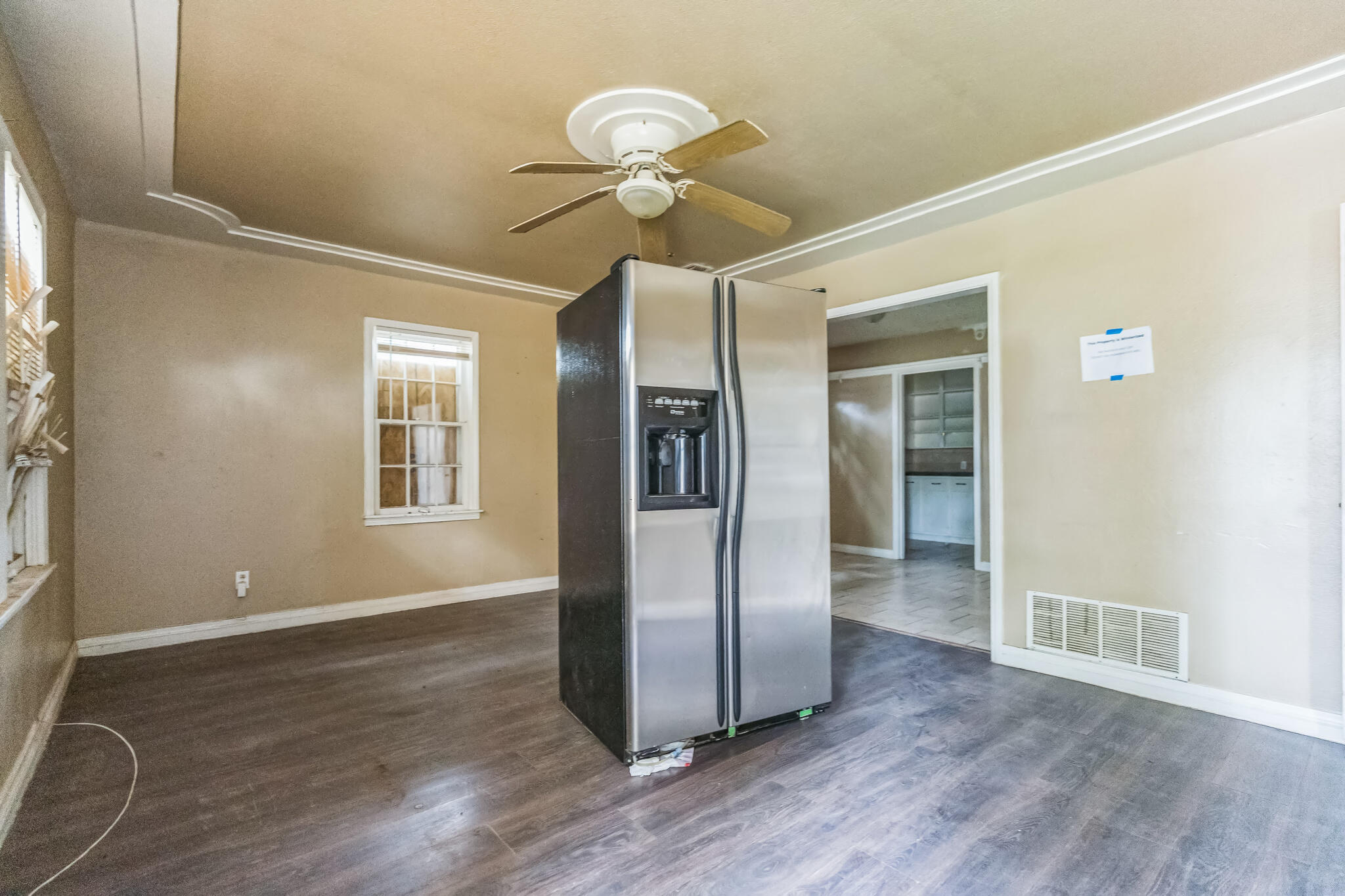 1510 33rd Street Lubbock, TX 79411 - Photo 20 of 33 a view of an empty room with wooden floor and a window