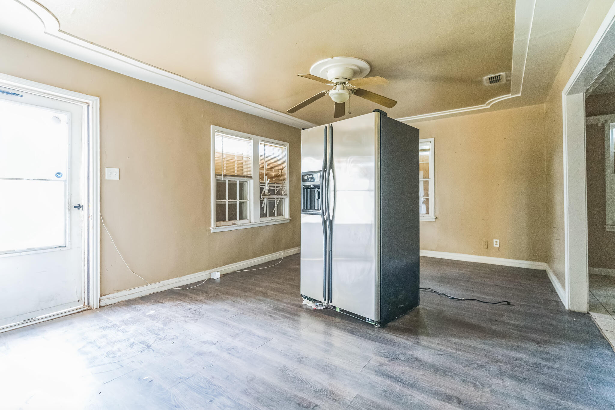 1510 33rd Street Lubbock, TX 79411 - Photo 21 of 33 an empty room with wooden floor fan and windows