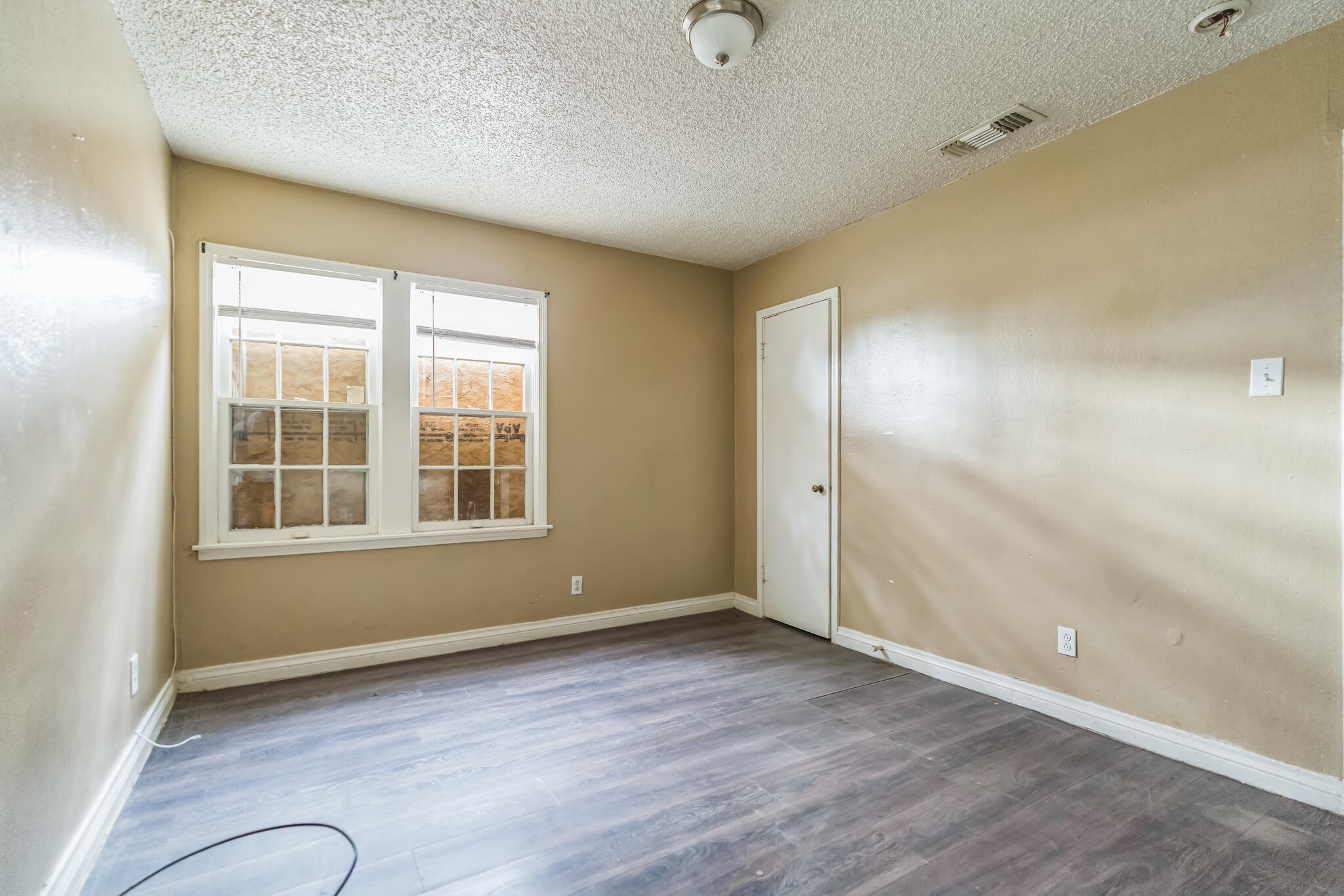 1510 33rd Street Lubbock, TX 79411 - Photo 30 of 33 an empty room with wooden floor and windows