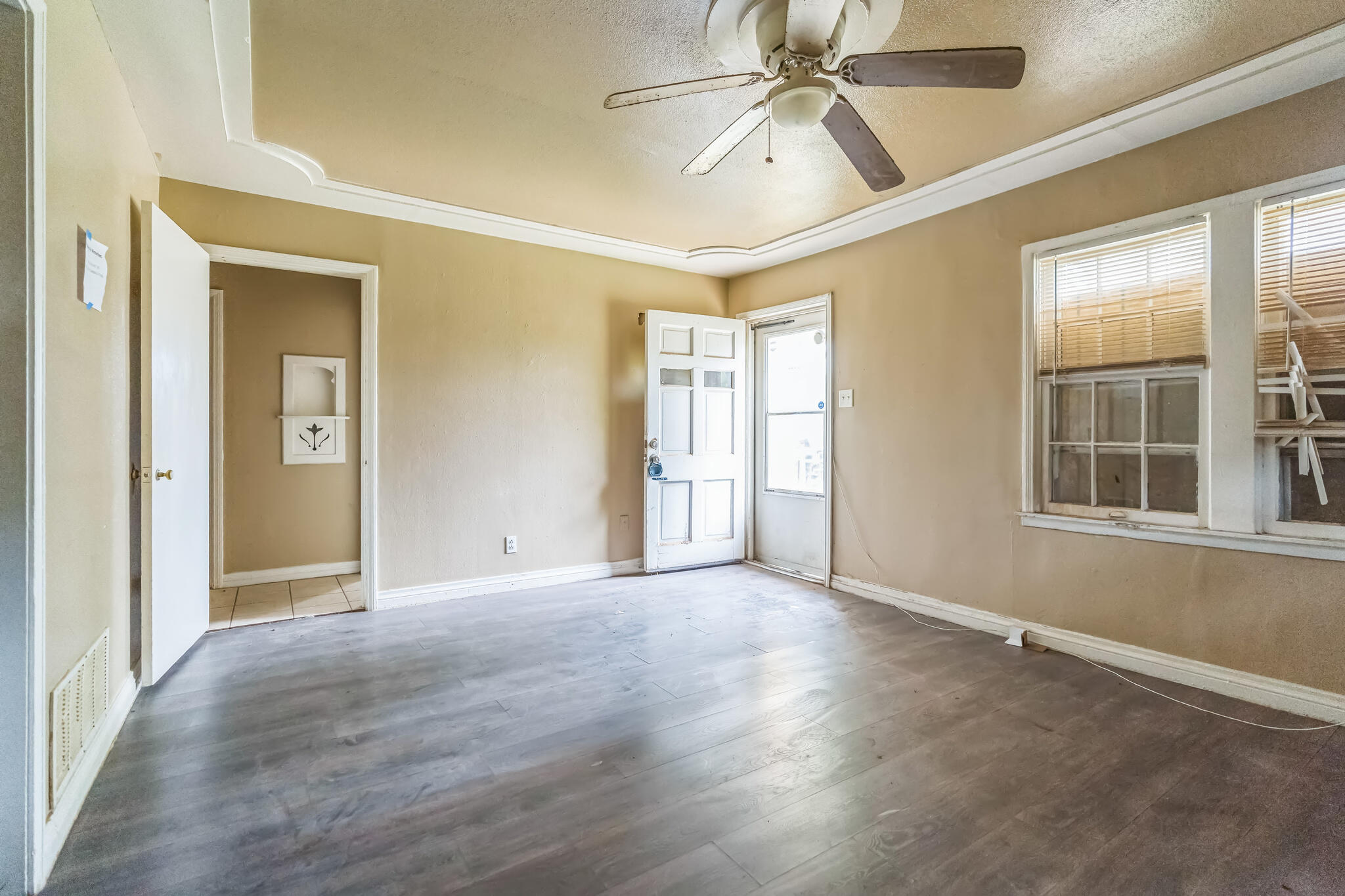1510 33rd Street Lubbock, TX 79411 - Photo 9 of 33 an empty room with wooden floor closet and windows