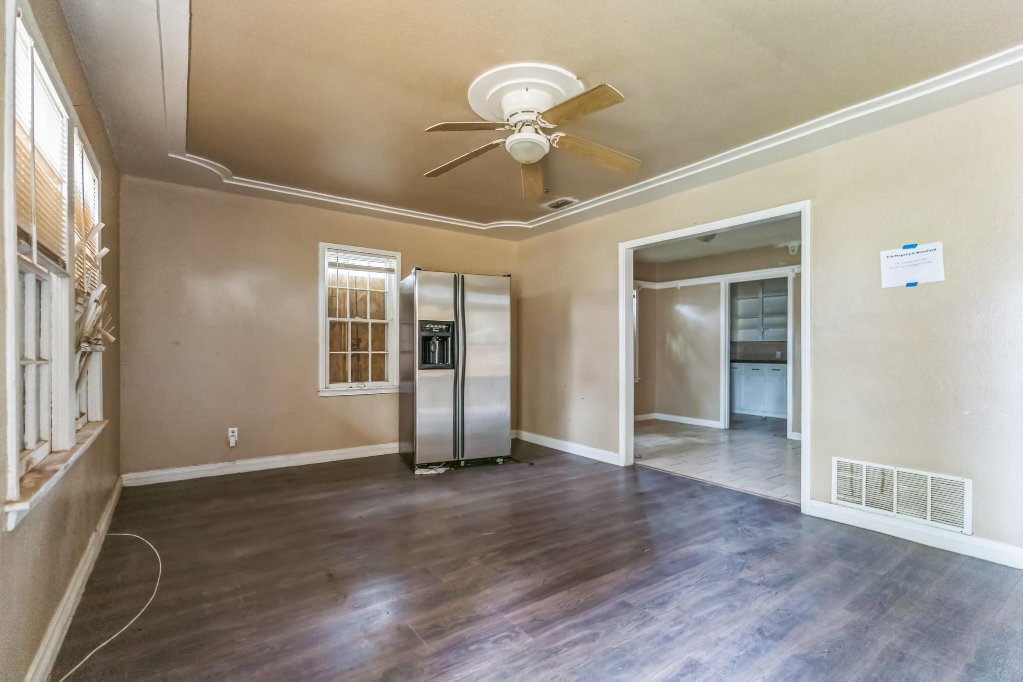1510 33rd Street Lubbock, TX 79411 - Photo 10 of 33 a view of an empty room with wooden floor and a window