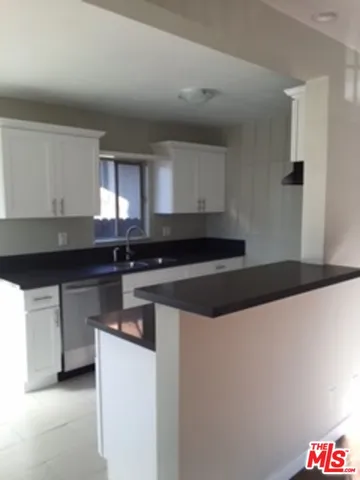 a kitchen with stainless steel appliances a sink and a stove