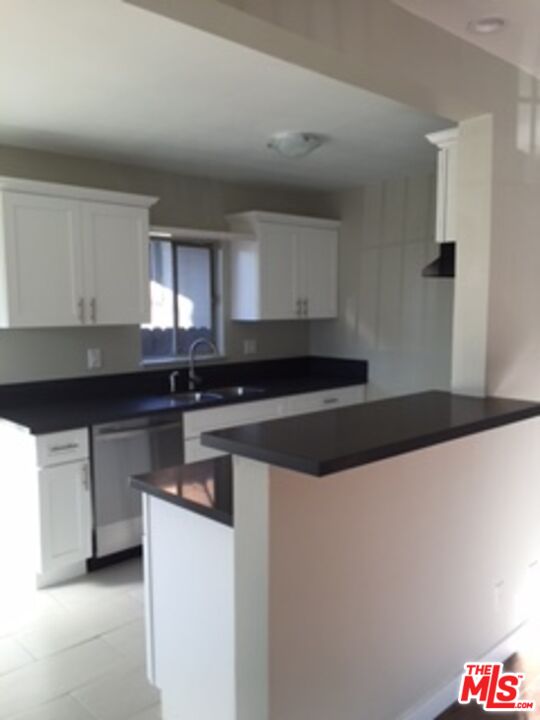 a kitchen with stainless steel appliances a sink and a stove