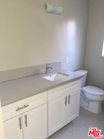 a bathroom with a toilet a sink and a mirror