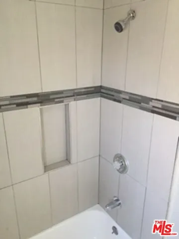 a bathroom with a shower and toilet