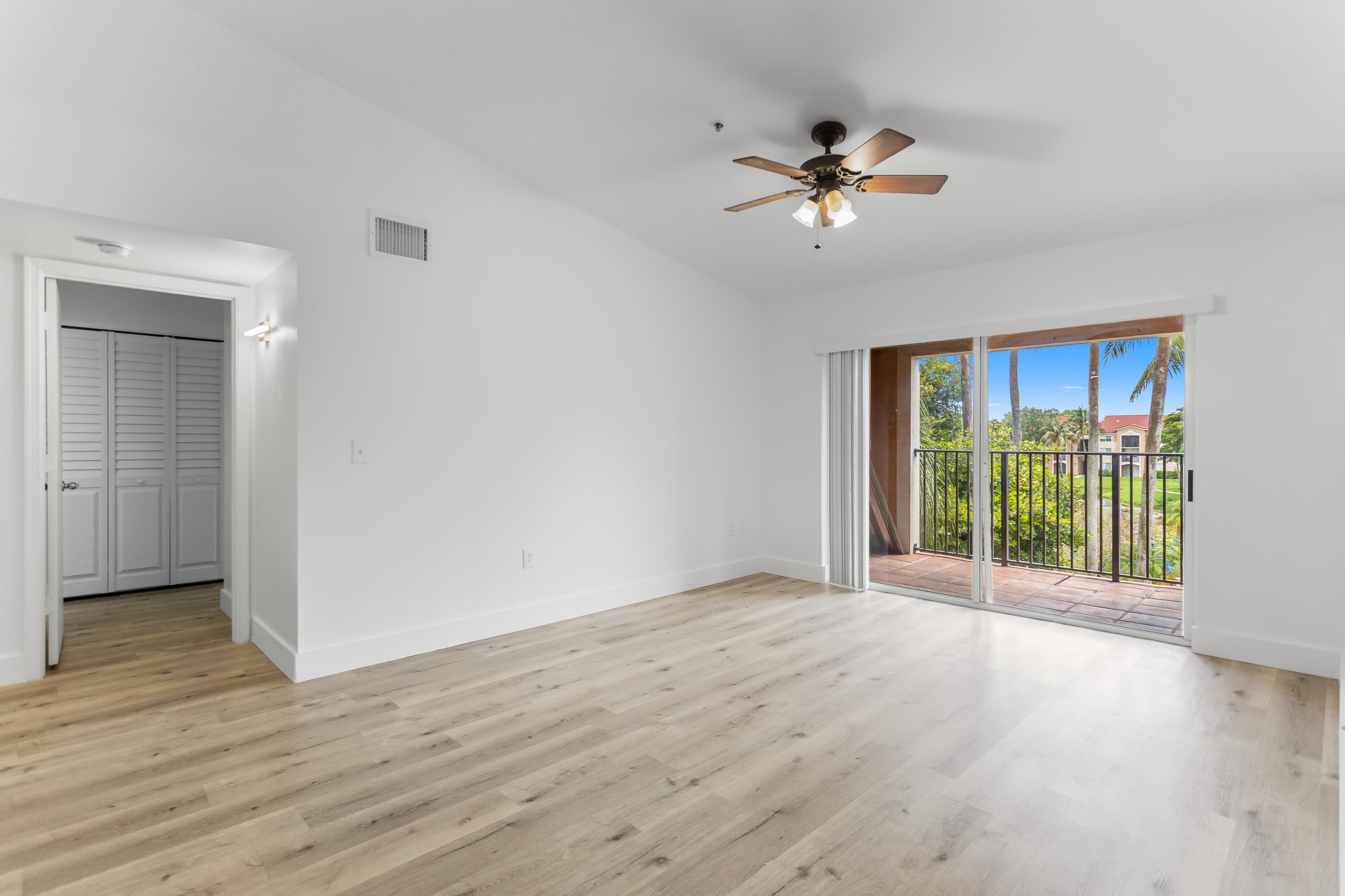 2113 Renaissance Boulevard, Unit 306 Miramar, FL 33025 - Photo 16 of 59 a view of an empty room with wooden floor and a window