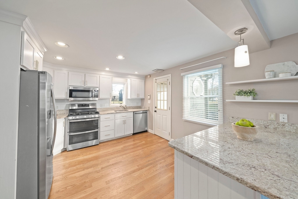 91 Prospect Street Canton, MA 02021 - Photo 14 of 41 a kitchen with a sink a counter top space stainless steel appliances and cabinets