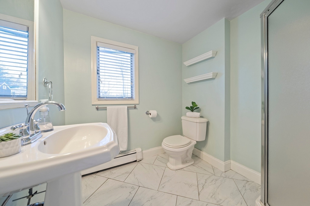 91 Prospect Street Canton, MA 02021 - Photo 18 of 41 a bathroom with a sink toilet a mirror and shower