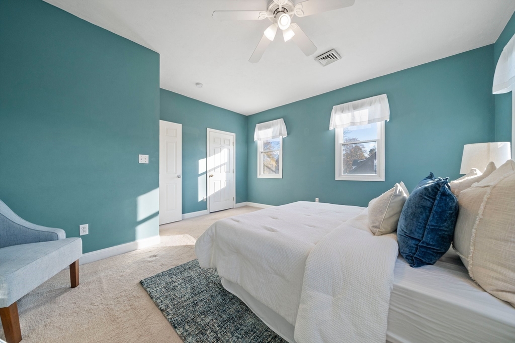 91 Prospect Street Canton, MA 02021 - Photo 21 of 41 a bedroom with a large bed and a chandelier