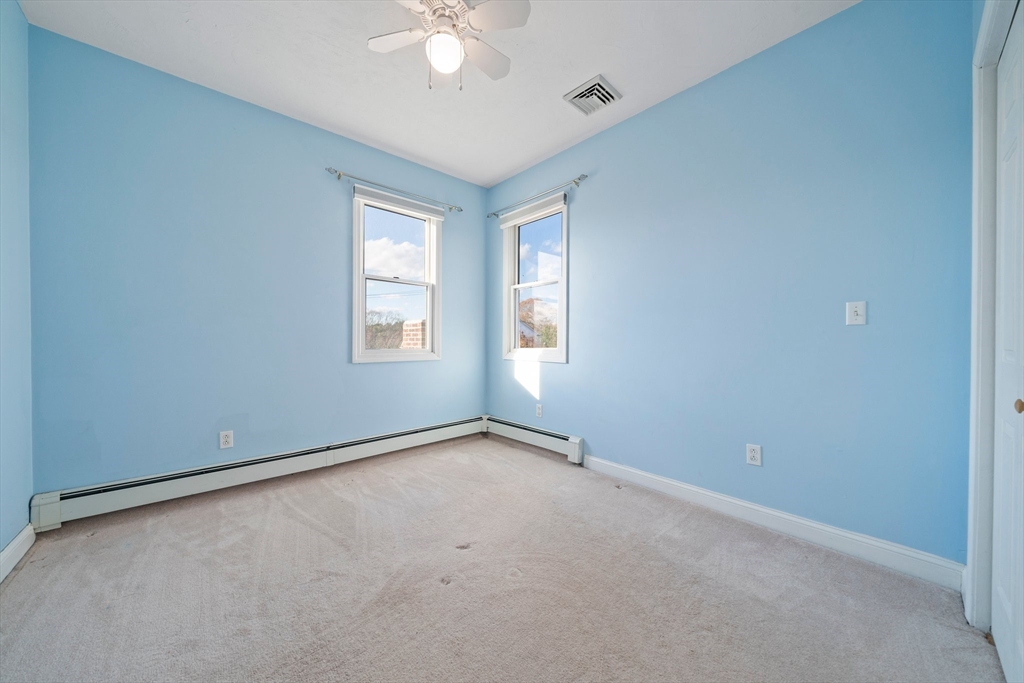 91 Prospect Street Canton, MA 02021 - Photo 23 of 41 an empty room with windows and chandelier fan