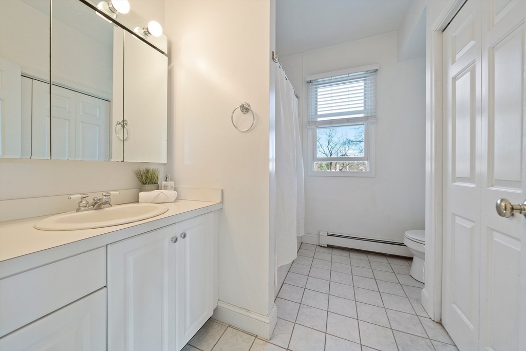 91 Prospect Street Canton, MA 02021 - Photo 24 of 41 a bathroom with a sink a toilet and a mirror