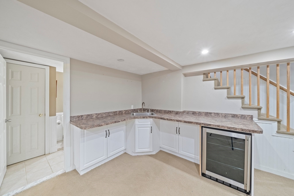 91 Prospect Street Canton, MA 02021 - Photo 30 of 41 a bathroom with a granite countertop sink and washing machine