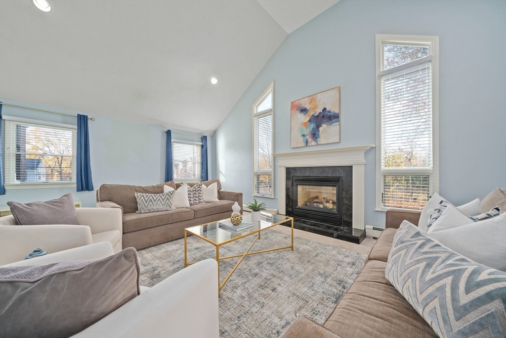 91 Prospect Street Canton, MA 02021 - Photo 3 of 41 a living room with furniture a fireplace and a large window