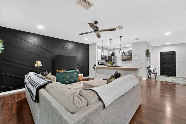 a kitchen with stainless steel appliances granite countertop a sink a stove and a refrigerator