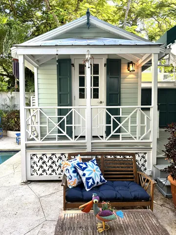 a view of a patio with table and chairs potted plants