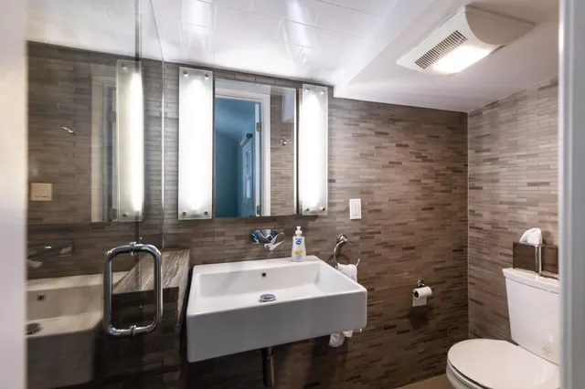 a view of a patio with chairs and table under an umbrella