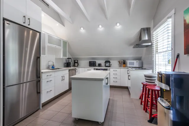 a view of a patio with a table and chairs under an umbrella