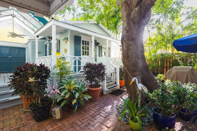 a kitchen with a table chairs refrigerator and cabinets