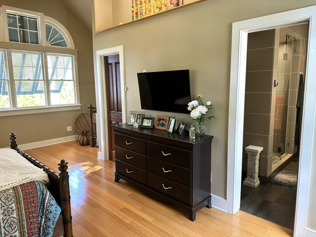a living room with furniture a flat screen tv and kitchen view