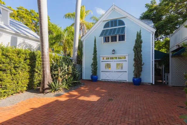 a view of a patio with table and chairs and potted plants