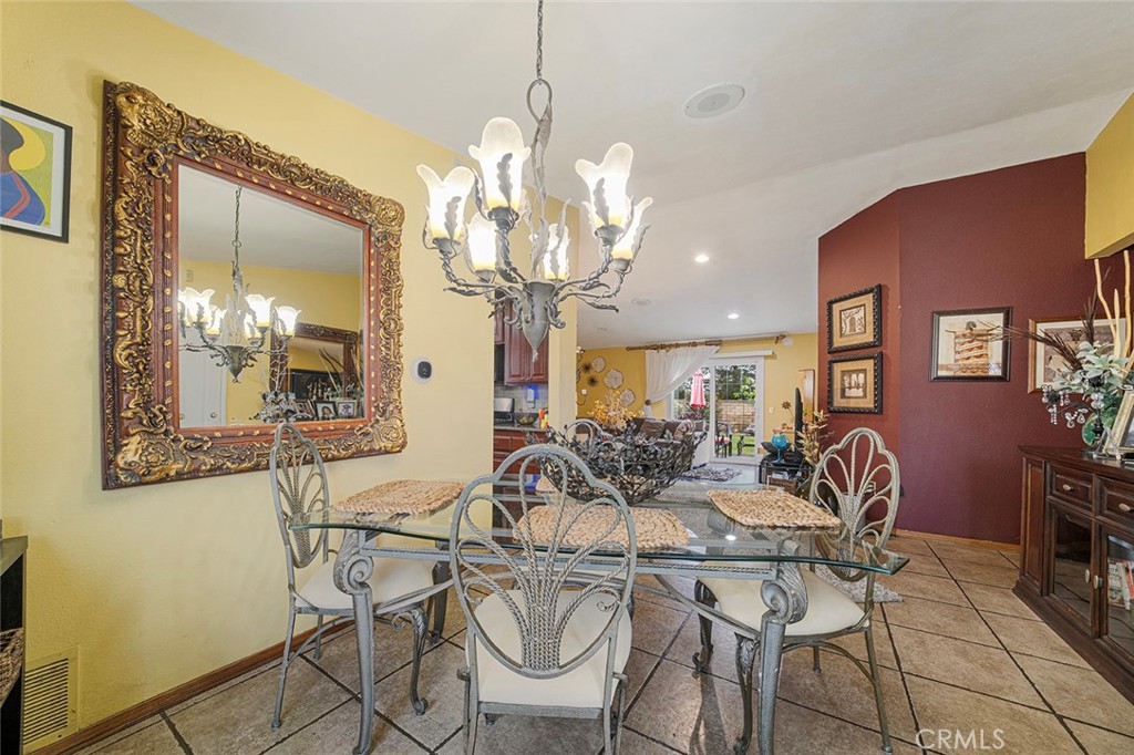 15465 Raymond Avenue Fontana, CA 92336 - Photo 12 of 27 a view of a dining room with furniture and chandelier