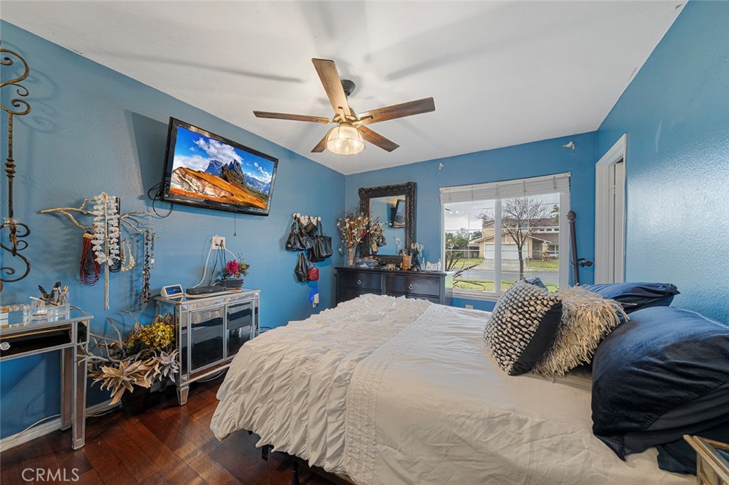 15465 Raymond Avenue Fontana, CA 92336 - Photo 15 of 27 a bedroom with a bed and a flat screen tv