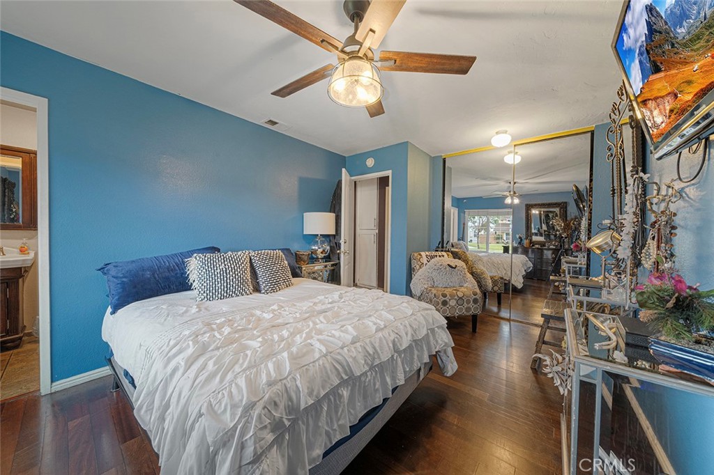 15465 Raymond Avenue Fontana, CA 92336 - Photo 16 of 27 a bedroom with bed mirror and window
