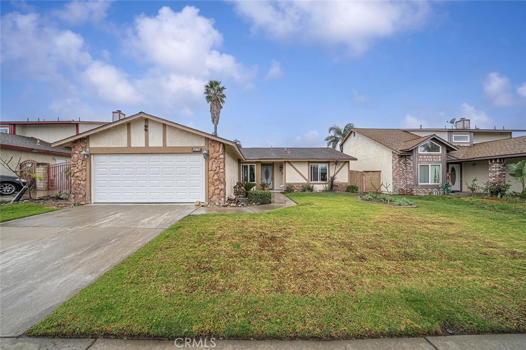 15465 Raymond Avenue Fontana, CA 92336 - Photo 18 of 27 a front view of a house with a yard