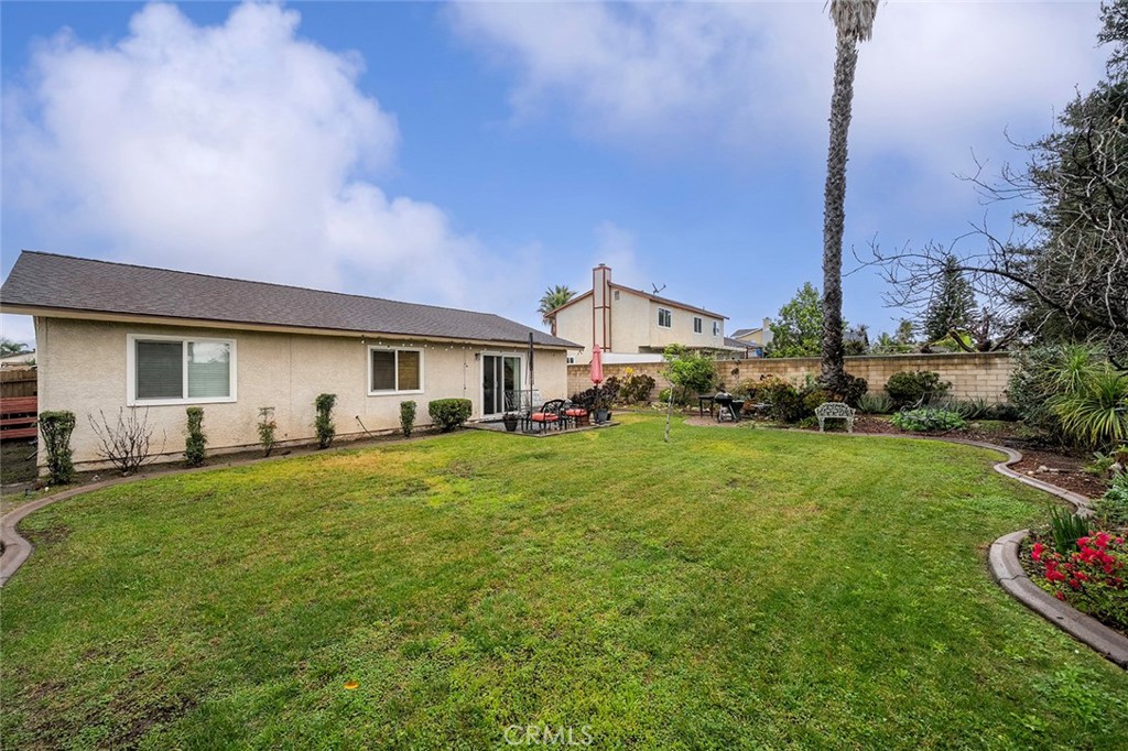 15465 Raymond Avenue Fontana, CA 92336 - Photo 22 of 27 a front view of house with a garden