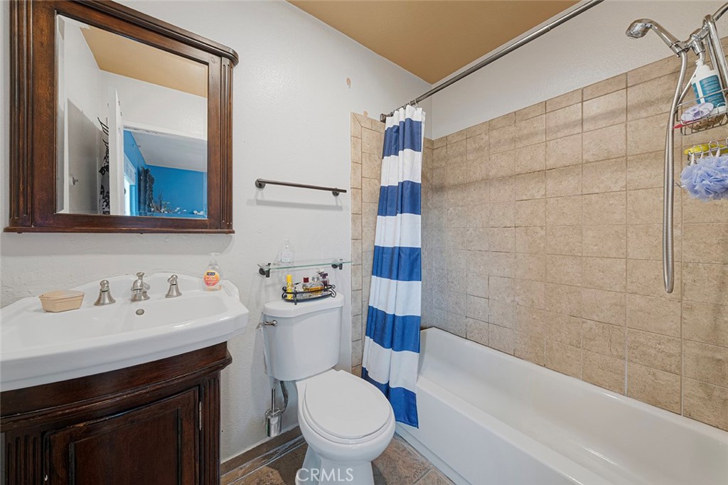 15465 Raymond Avenue Fontana, CA 92336 - Photo 5 of 27 a bathroom with a sink toilet vanity and shower