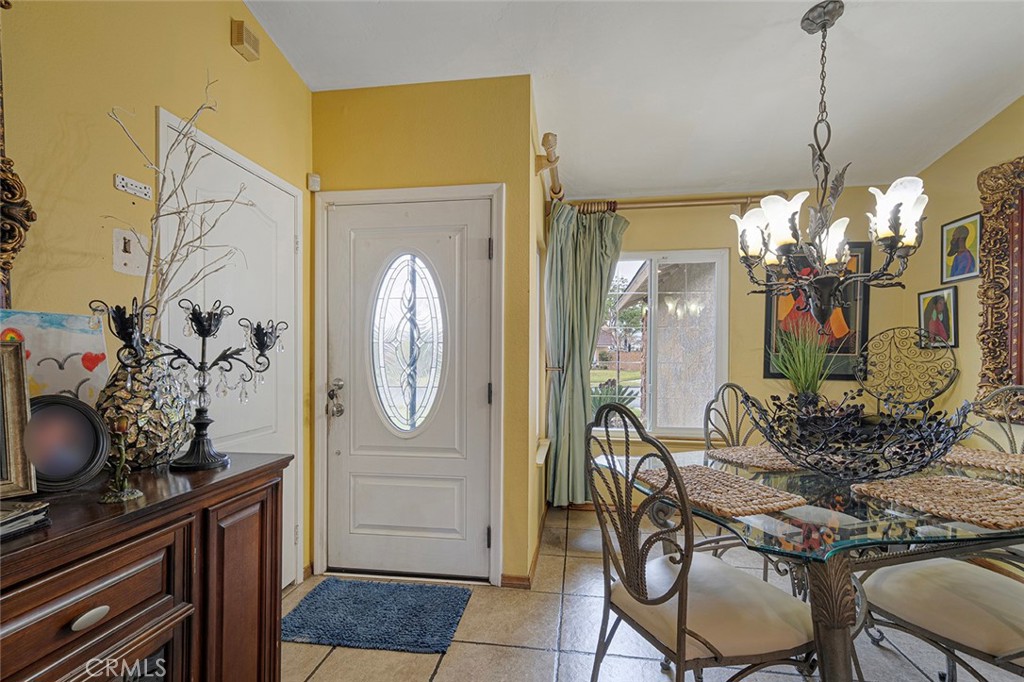 15465 Raymond Avenue Fontana, CA 92336 - Photo 7 of 27 a view of a dining room with furniture and chandelier