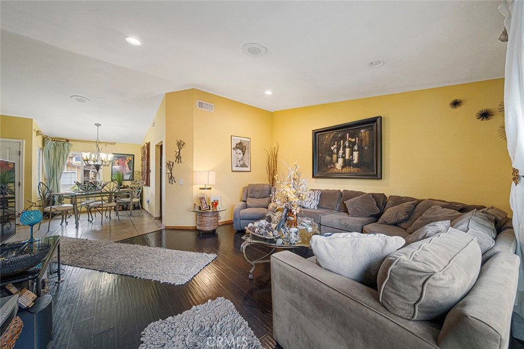 15465 Raymond Avenue Fontana, CA 92336 - Photo 9 of 27 a living room with furniture wooden floor and a large window