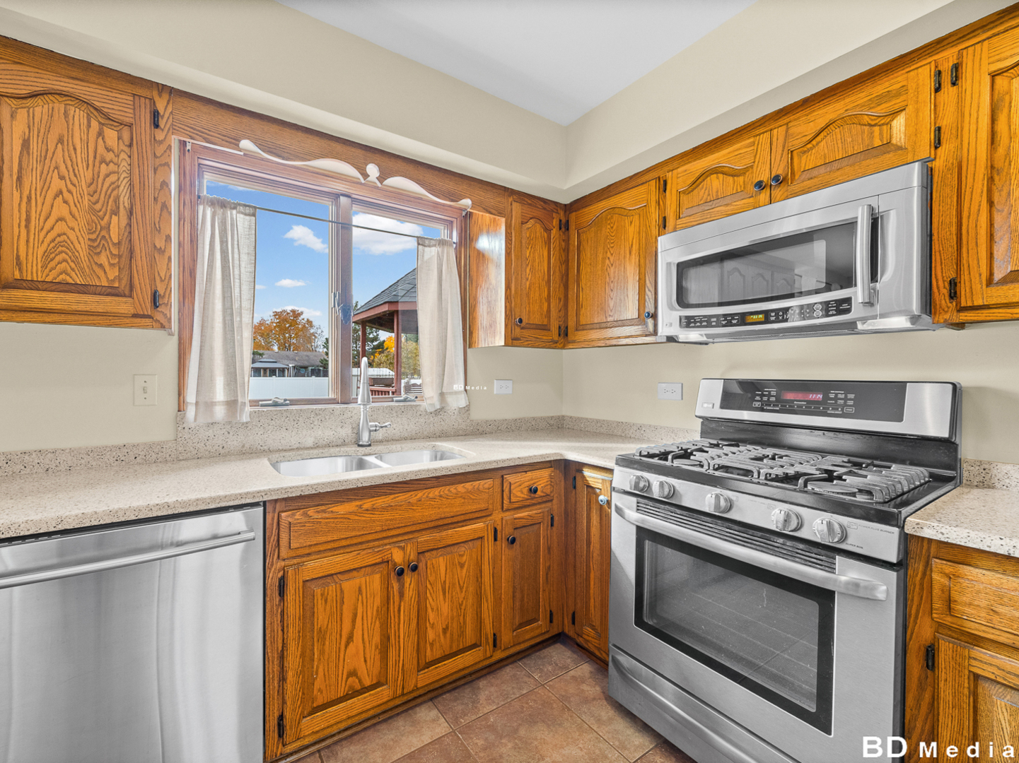 1525 Cimarron Drive New Lenox, IL 60451 - Photo 13 of 41 a kitchen with stainless steel appliances a stove sink and microwave