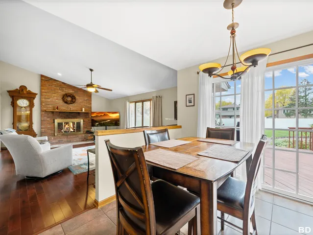 a dining room with furniture a chandelier and wooden floor
