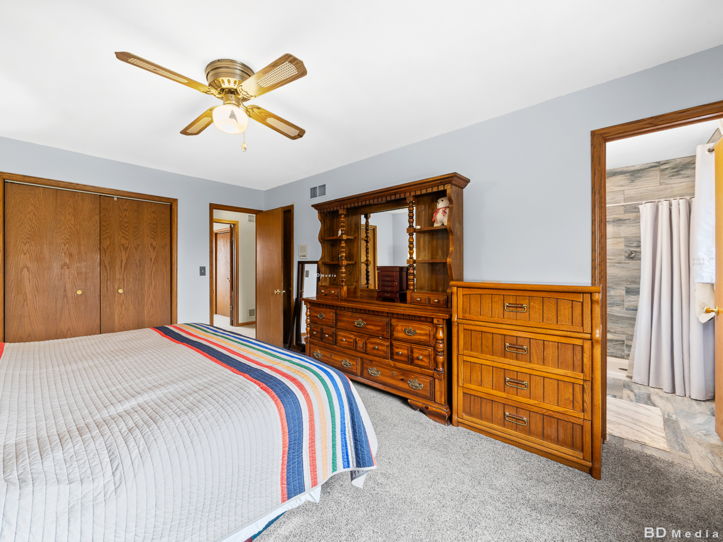1525 Cimarron Drive New Lenox, IL 60451 - Photo 27 of 41 a bedroom with a bed and a chandelier