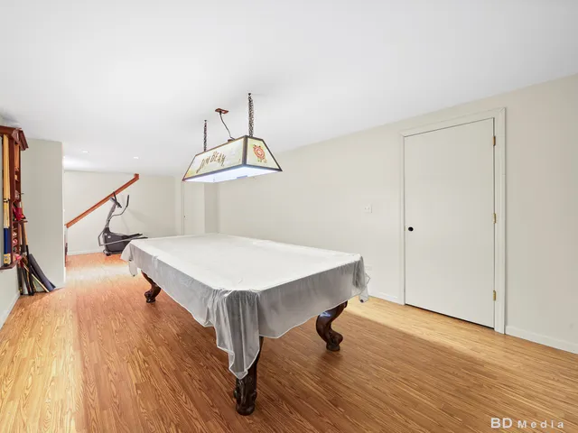 a room with table chairs and wooden floor