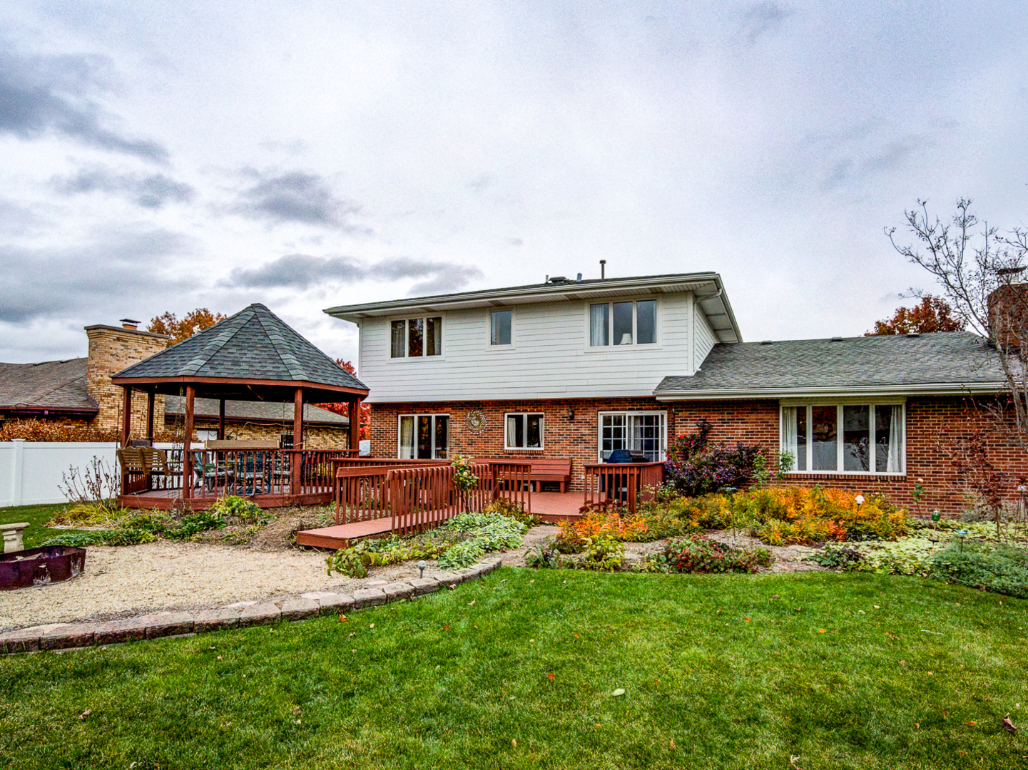 1525 Cimarron Drive New Lenox, IL 60451 - Photo 32 of 41 a front view of a house with garden and trees