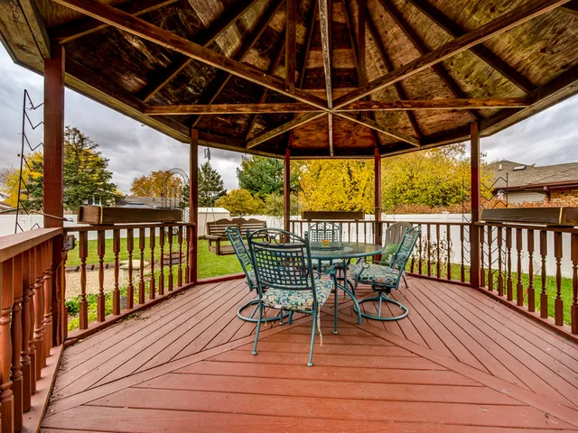 a view of a chairs and table in the balcony