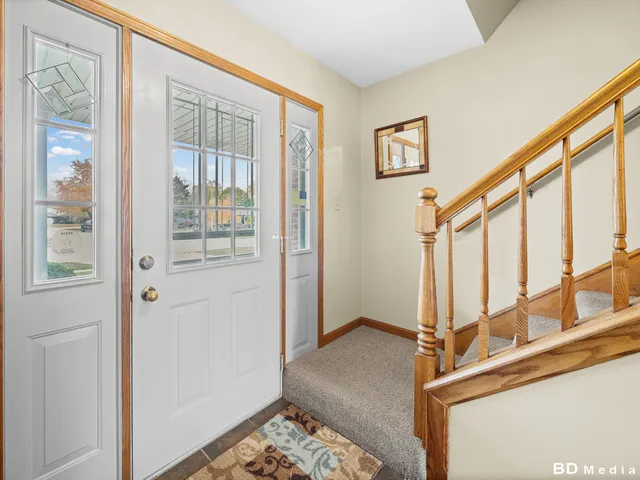 a view of an entryway with wooden floor