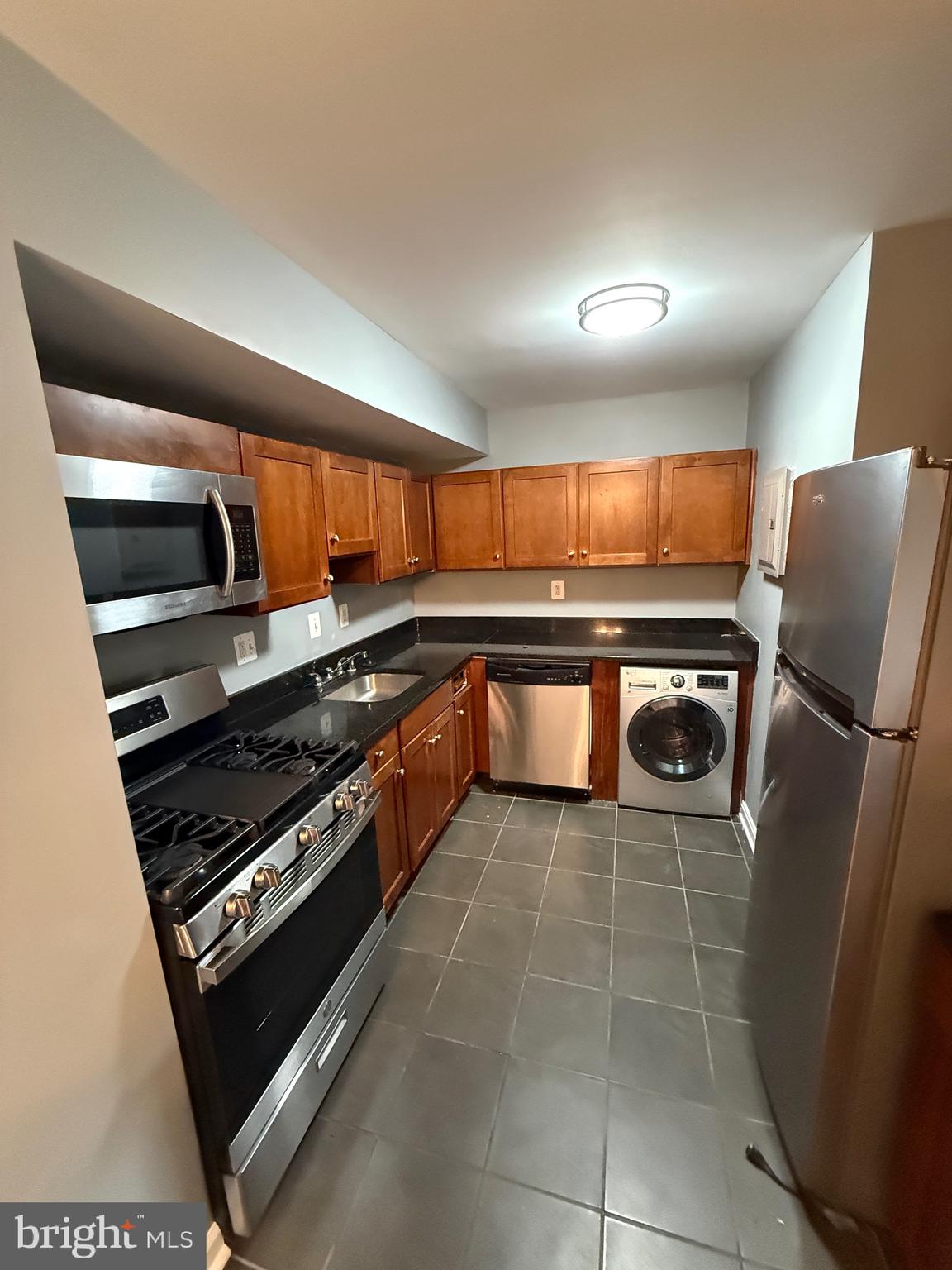 3103 Naylor Road Southeast, Unit B Washington, DC 20020 - Photo 5 of 16 a kitchen with stainless steel appliances granite countertop a stove a sink and a refrigerator