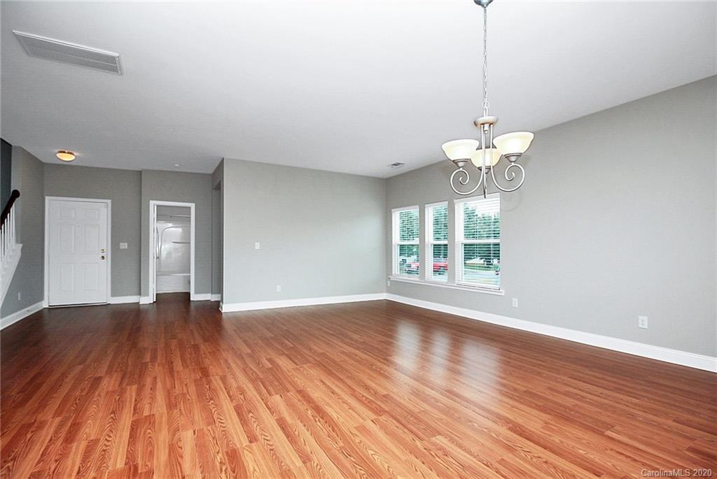 9522 Seamill Road Charlotte, NC 28278 - Photo 11 of 43 a view of an empty room with wooden floor and a window