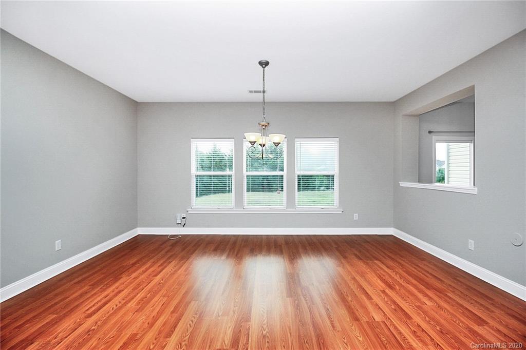 9522 Seamill Road Charlotte, NC 28278 - Photo 12 of 43 a view of an empty room with wooden floor and a window