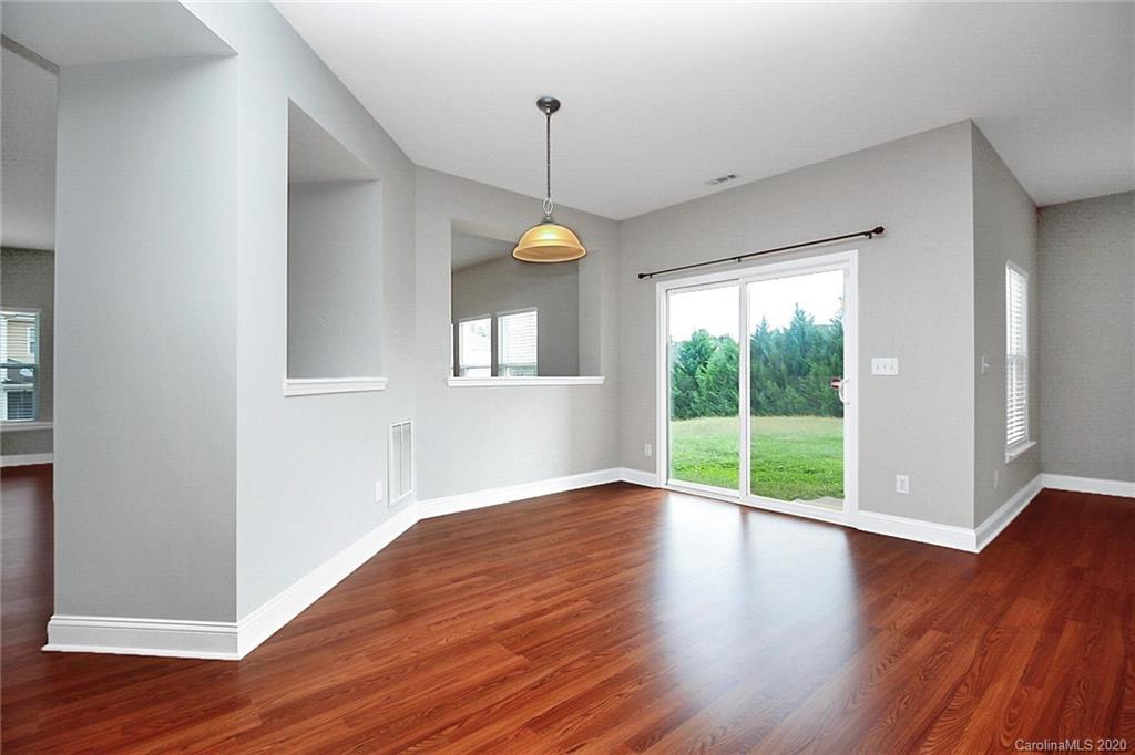 9522 Seamill Road Charlotte, NC 28278 - Photo 14 of 43 a view of an empty room with wooden floor and a window