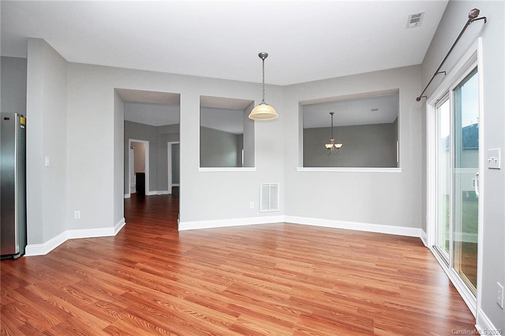 9522 Seamill Road Charlotte, NC 28278 - Photo 15 of 43 a view of a hallway with wooden floor and a room