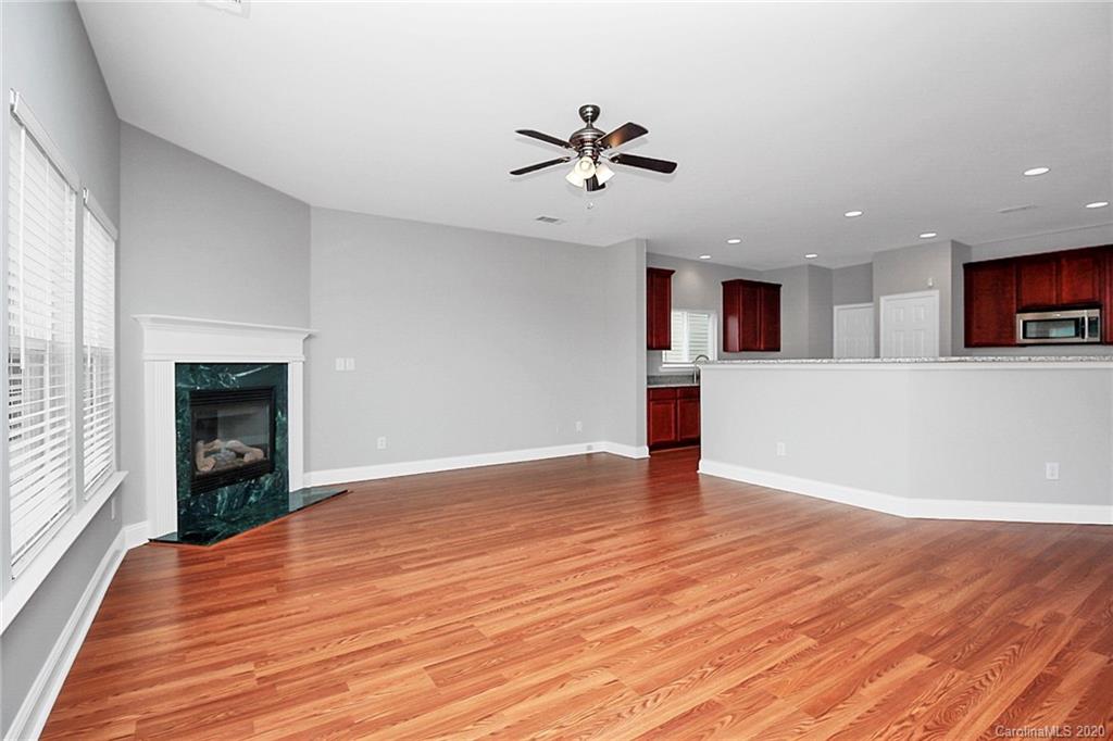 9522 Seamill Road Charlotte, NC 28278 - Photo 17 of 43 a view of empty room with wooden floor and fan