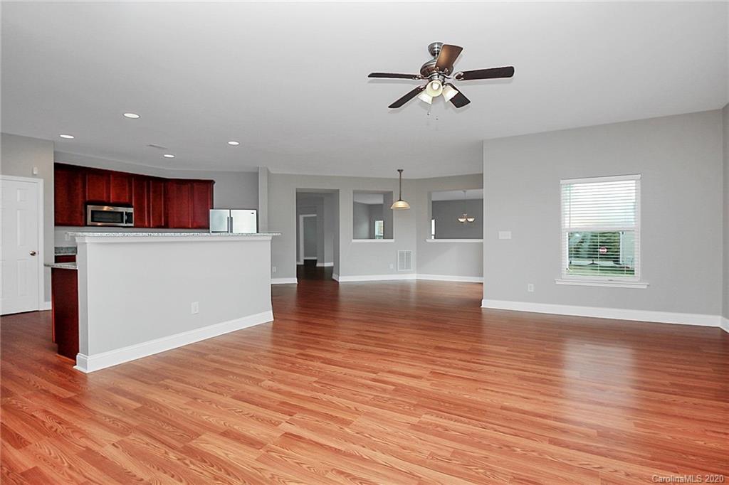 9522 Seamill Road Charlotte, NC 28278 - Photo 18 of 43 a view of empty room with wooden floor and window