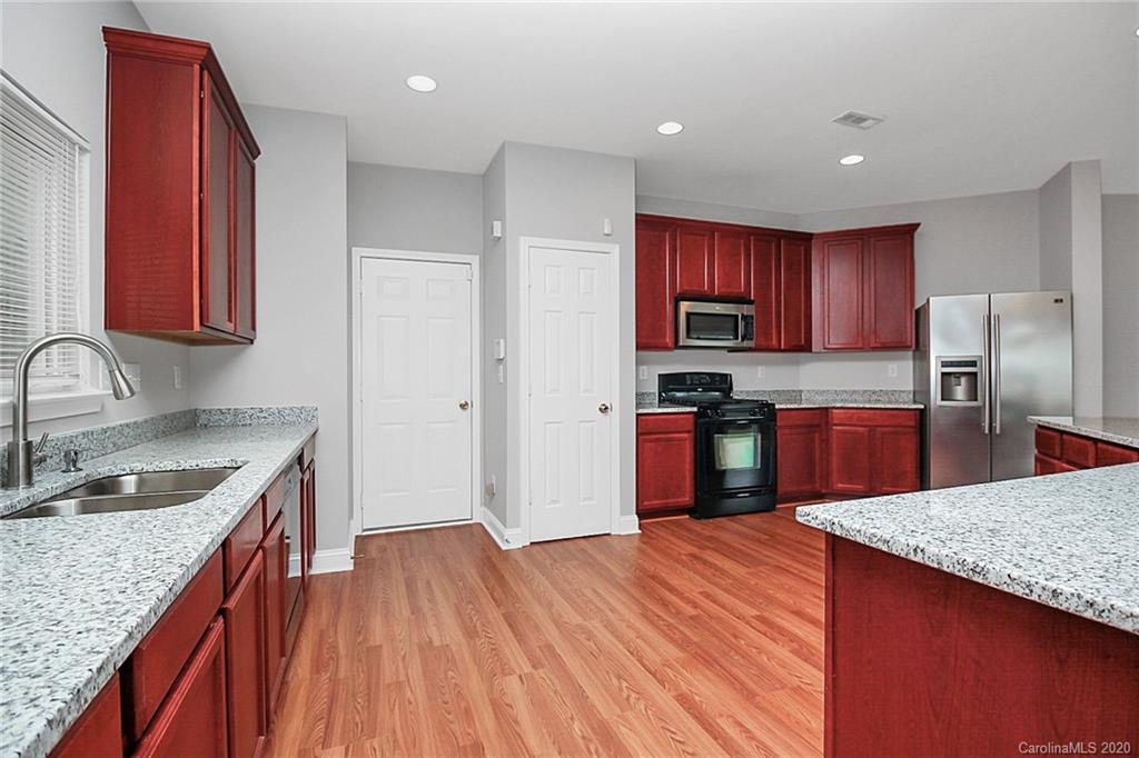 9522 Seamill Road Charlotte, NC 28278 - Photo 19 of 43 a kitchen with granite countertop stainless steel appliances and wooden cabinets