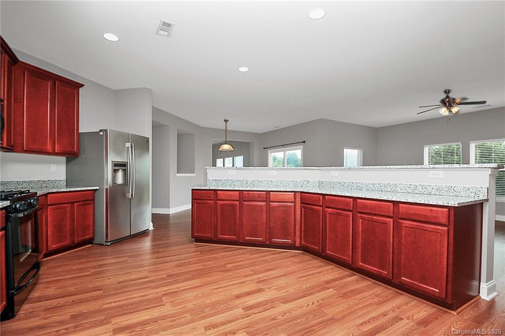 9522 Seamill Road Charlotte, NC 28278 - Photo 20 of 43 a spacious bathroom with a granite countertop sink and a mirror