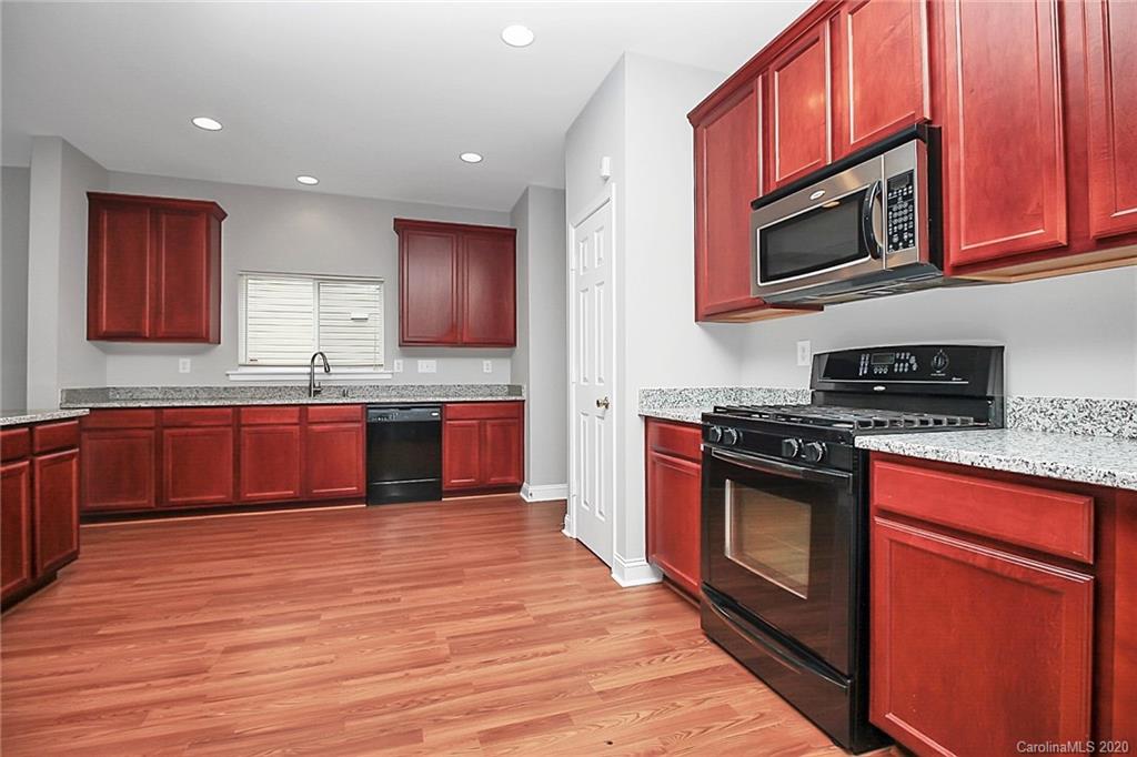 9522 Seamill Road Charlotte, NC 28278 - Photo 22 of 43 a kitchen with stainless steel appliances granite countertop a stove a microwave and a sink