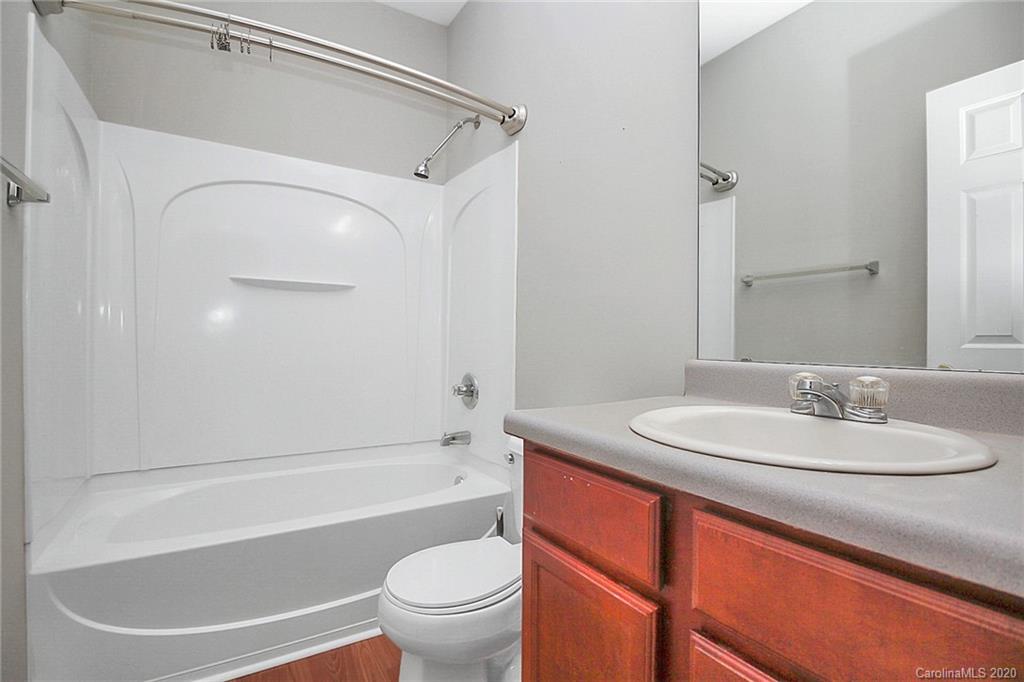 9522 Seamill Road Charlotte, NC 28278 - Photo 23 of 43 a bathroom with a granite countertop sink toilet mirror and bathtub